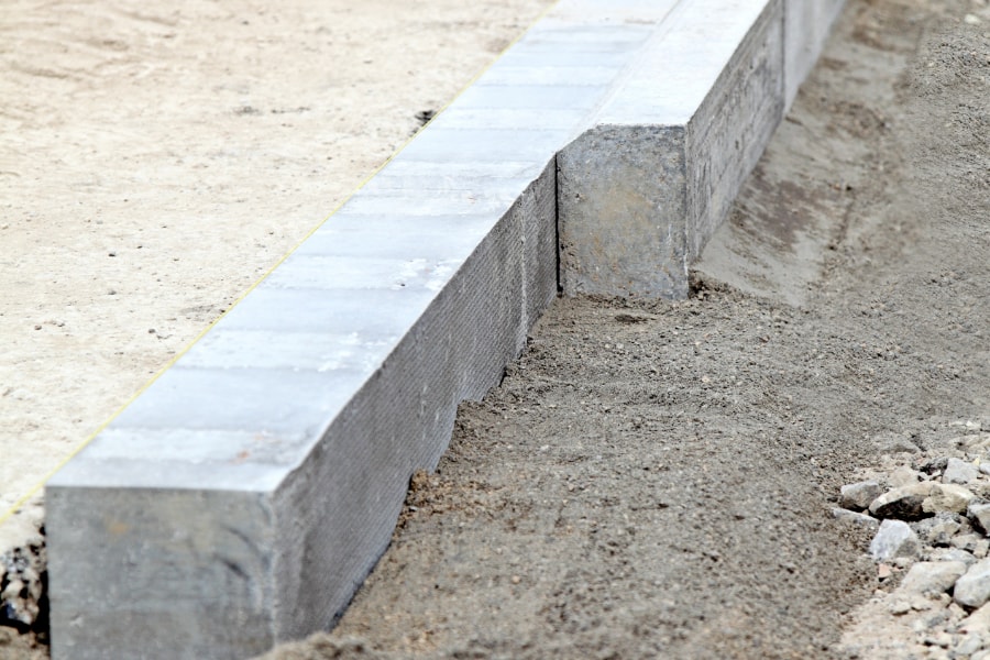 Road kerbs positioned and ready to be laid on newly constructed road in Swansea city centre